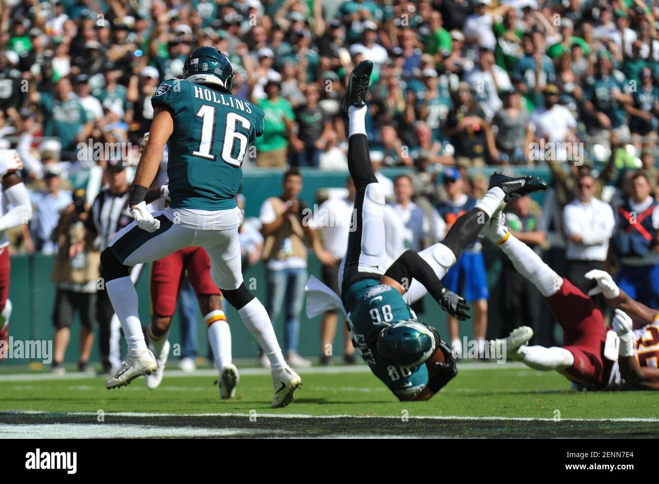 Arizona Cardinals vs. Philadelphia Eagles. NFL match poster. Two american  football players silhouette facing each other on the field. Clubs logo in  background. Rivalry concept photo. Stock Photo