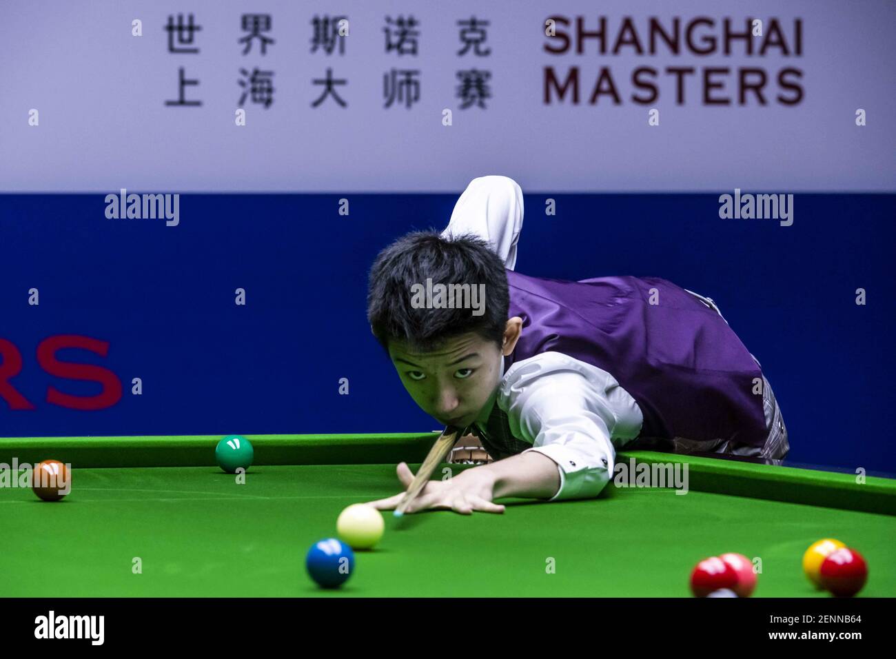 wu yize of china plays a shot to john higgins of scotland in the heldover match during the 2019 world snooker international championship in daqing cit stock photo alamy