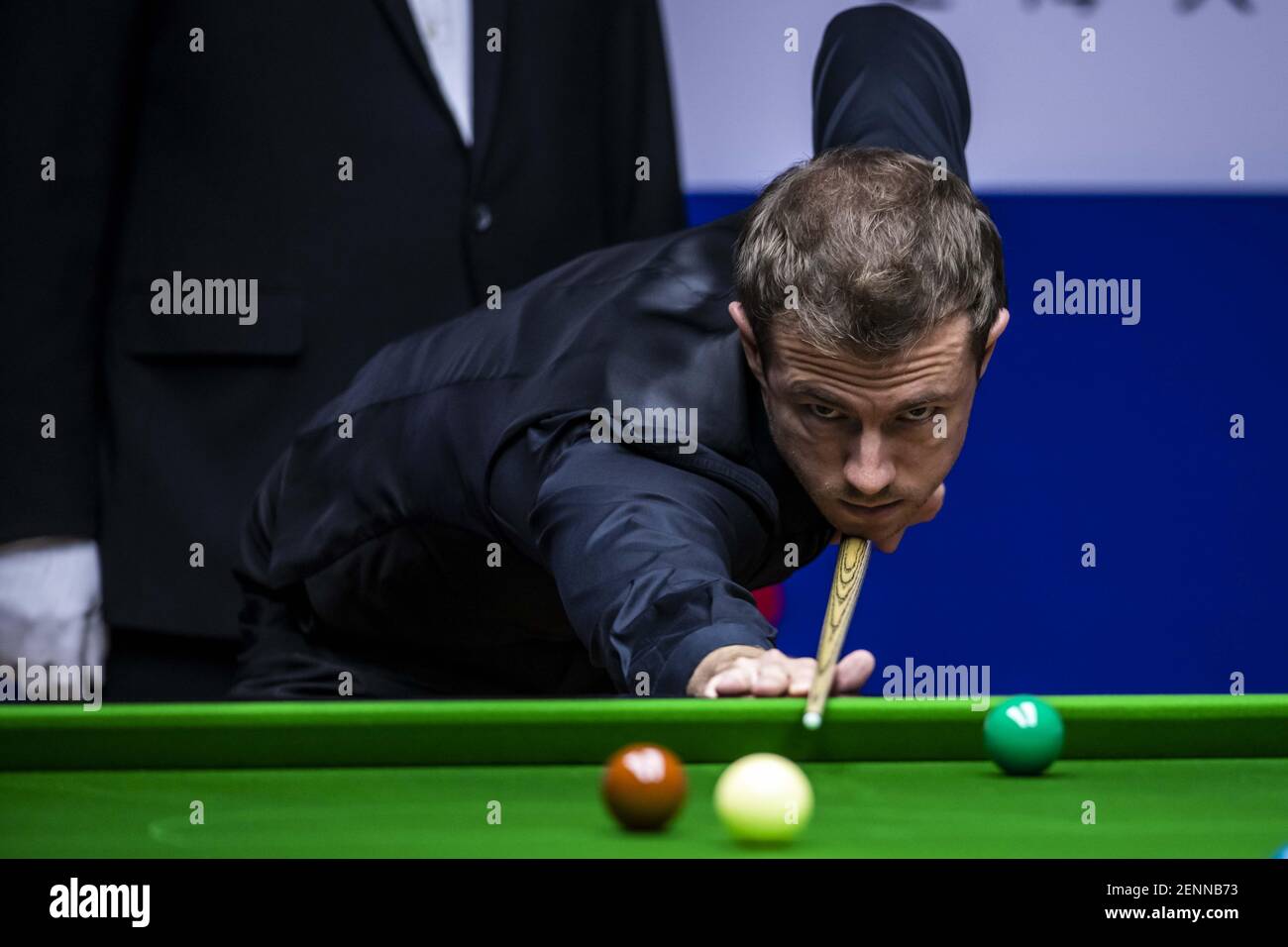 wu yize of china plays a shot to john higgins of scotland in the heldover match during the 2019 world snooker international championship in daqing cit stock photo alamy