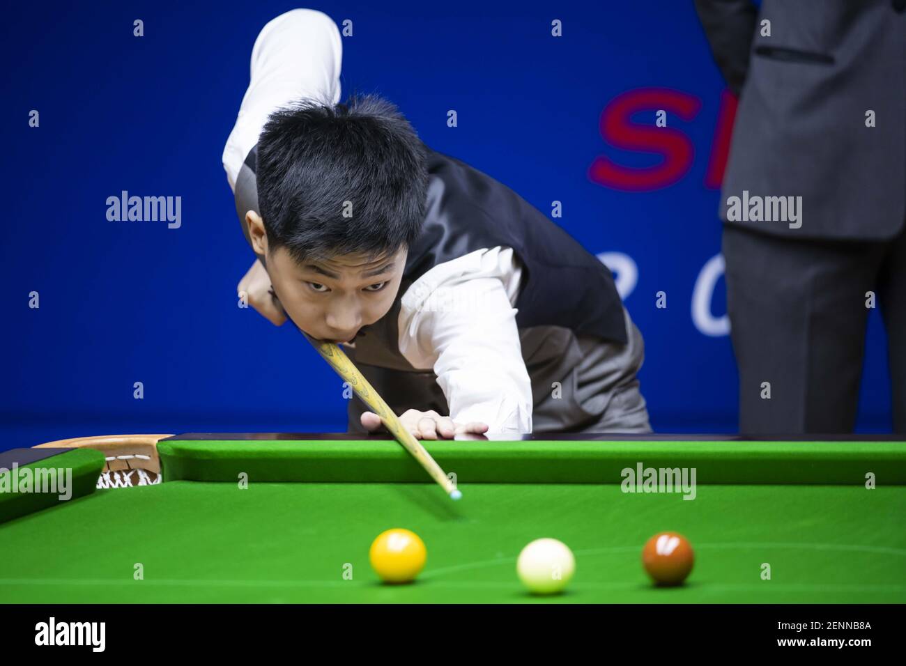 Chinese professional snooker player Wu Haotian plays a shot at the Round 1 of 2019 Snooker