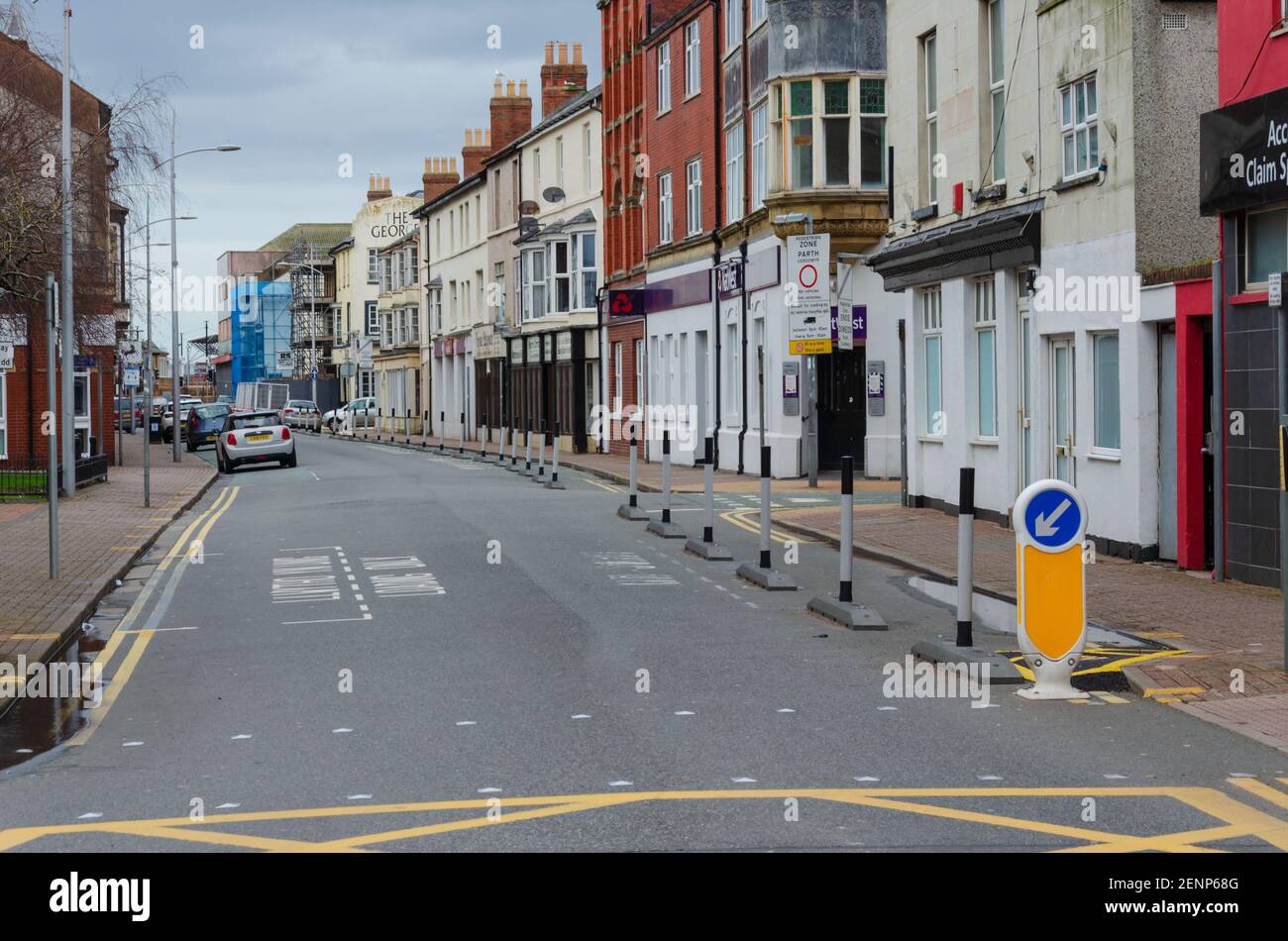 Rhyl, Denbighshire; UK: Feb 21, 2021: Queen Street on a Sunday afternoon with very few people during the pandemic lockdown. Parking bays coned off to Stock Photo