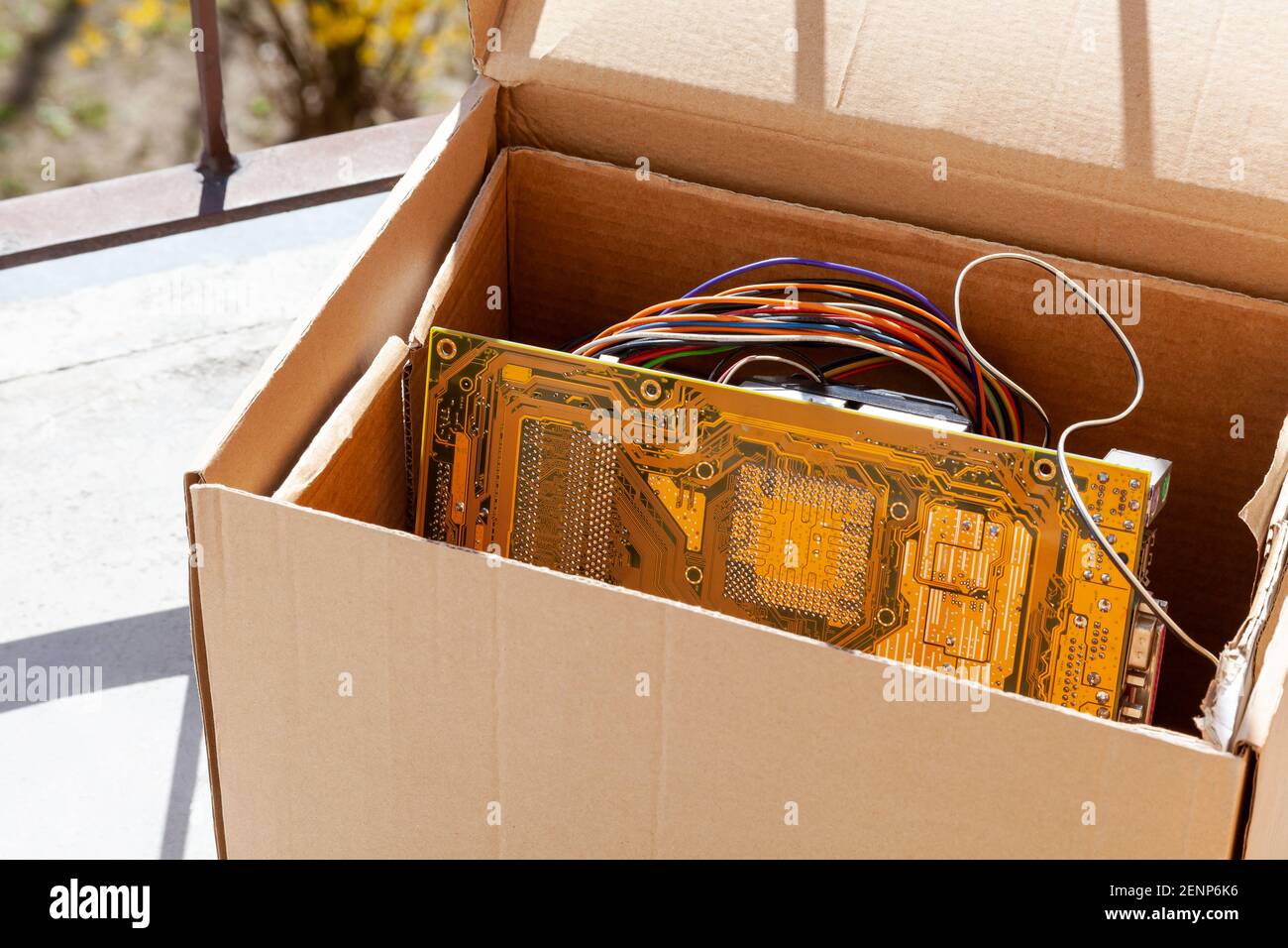 Throwing away electronic waste, obsolete pc components in a carton box