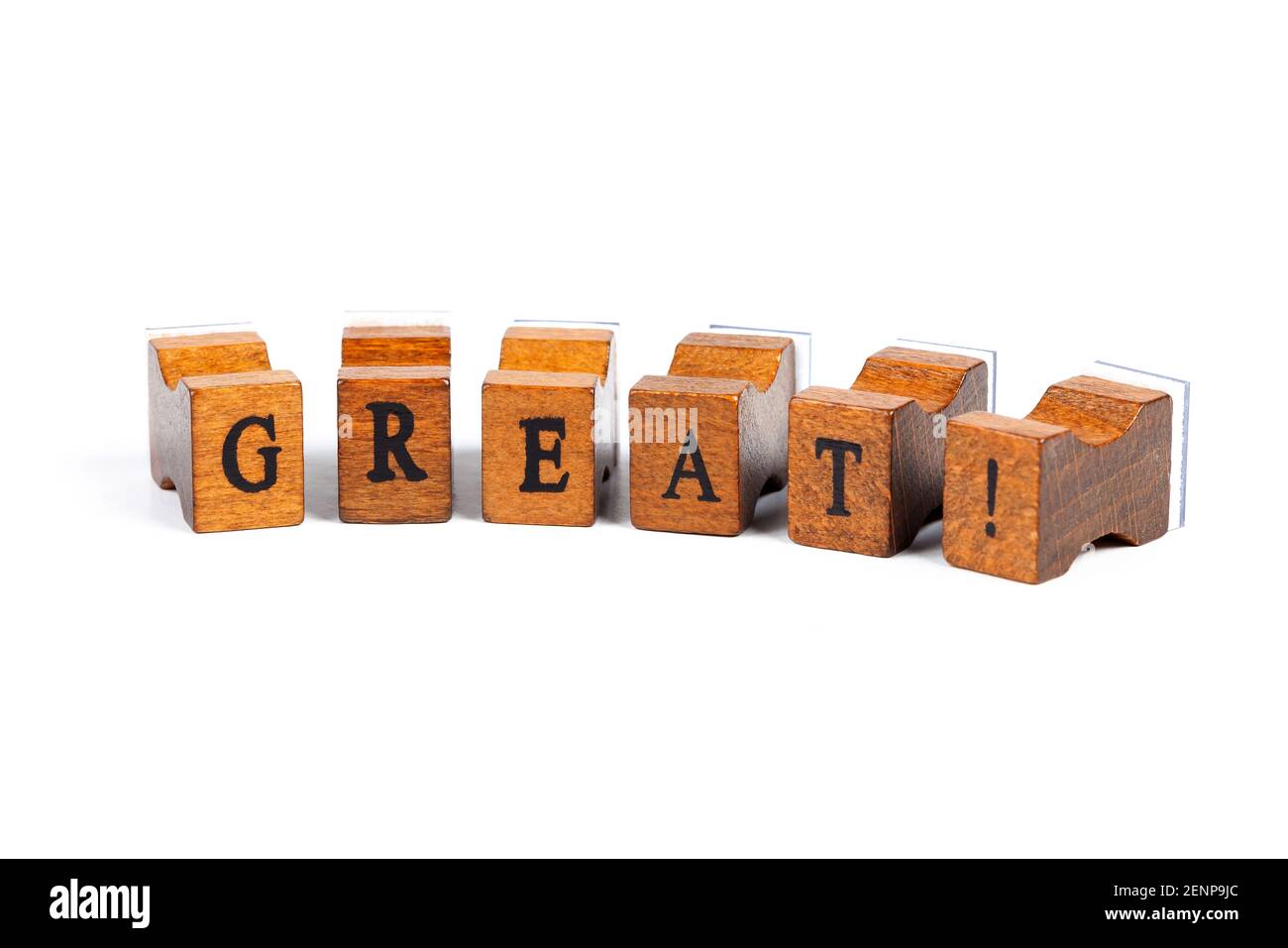 Word Great! Small wooden moveable type rubber stamp font letters isolated on white background. Praise, compliment and applause, admiration abstract co Stock Photo