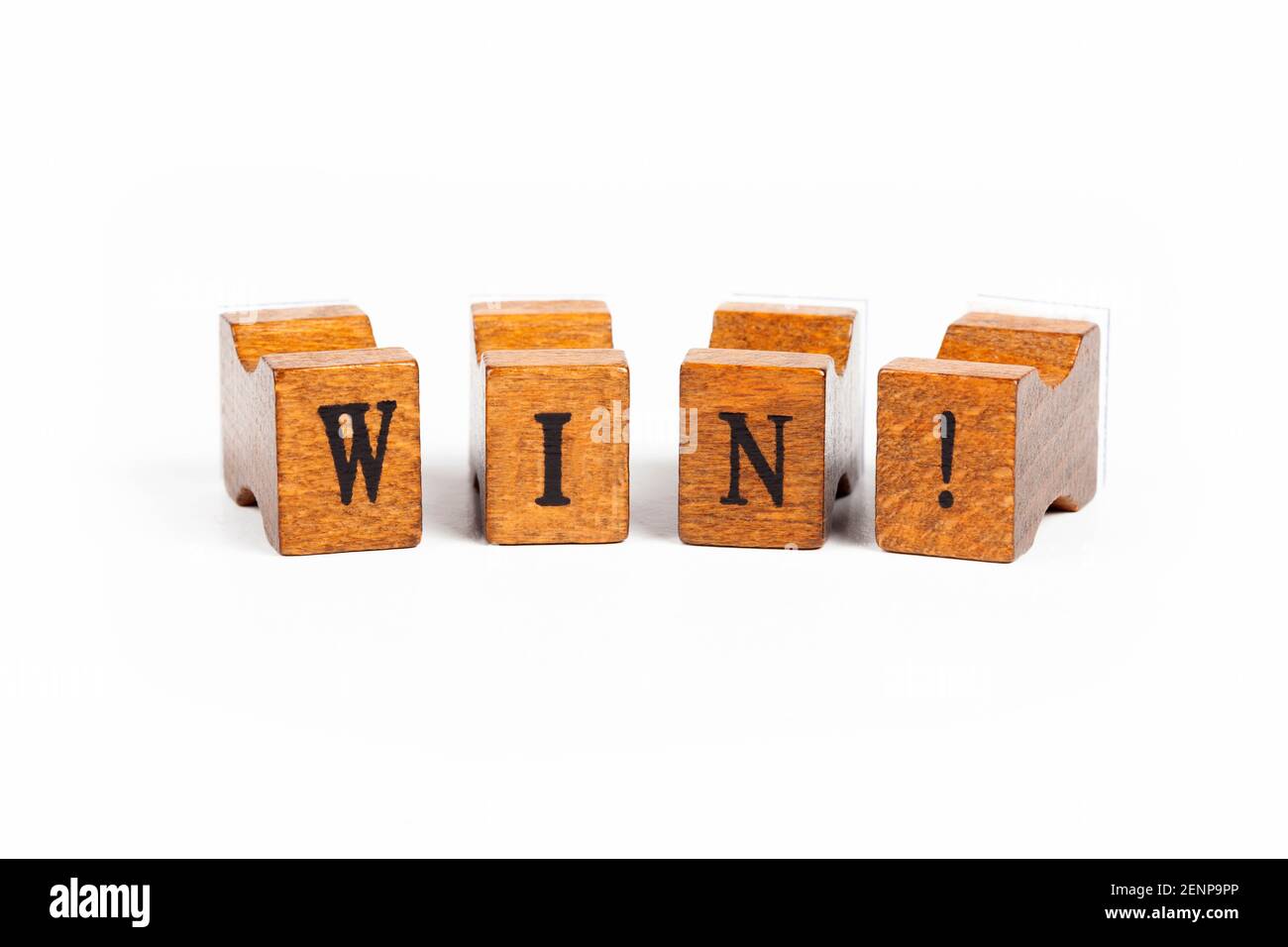 Word WIN! Small wooden moveable type old rubber stamp font letters isolated on white background Winning, success and triumph, motivation simple abstra Stock Photo