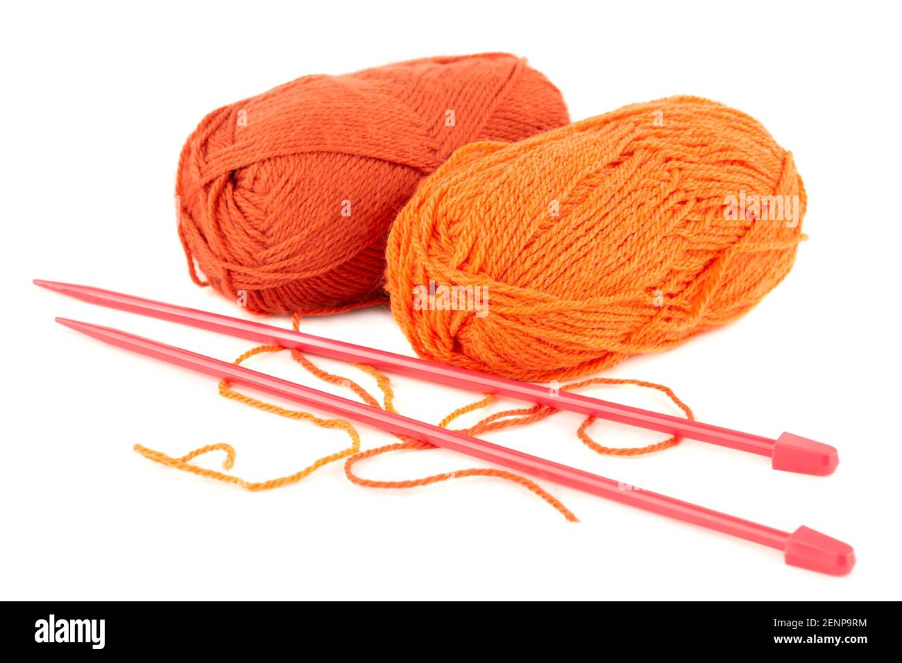 Two knitting yarn clews and knitting needles isolated on white background. Stock Photo