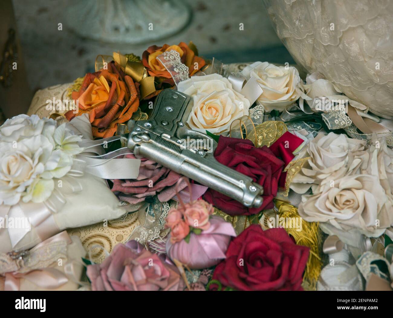 Italy, Sicily, Palermo, still life of a gun and roses Stock Photo