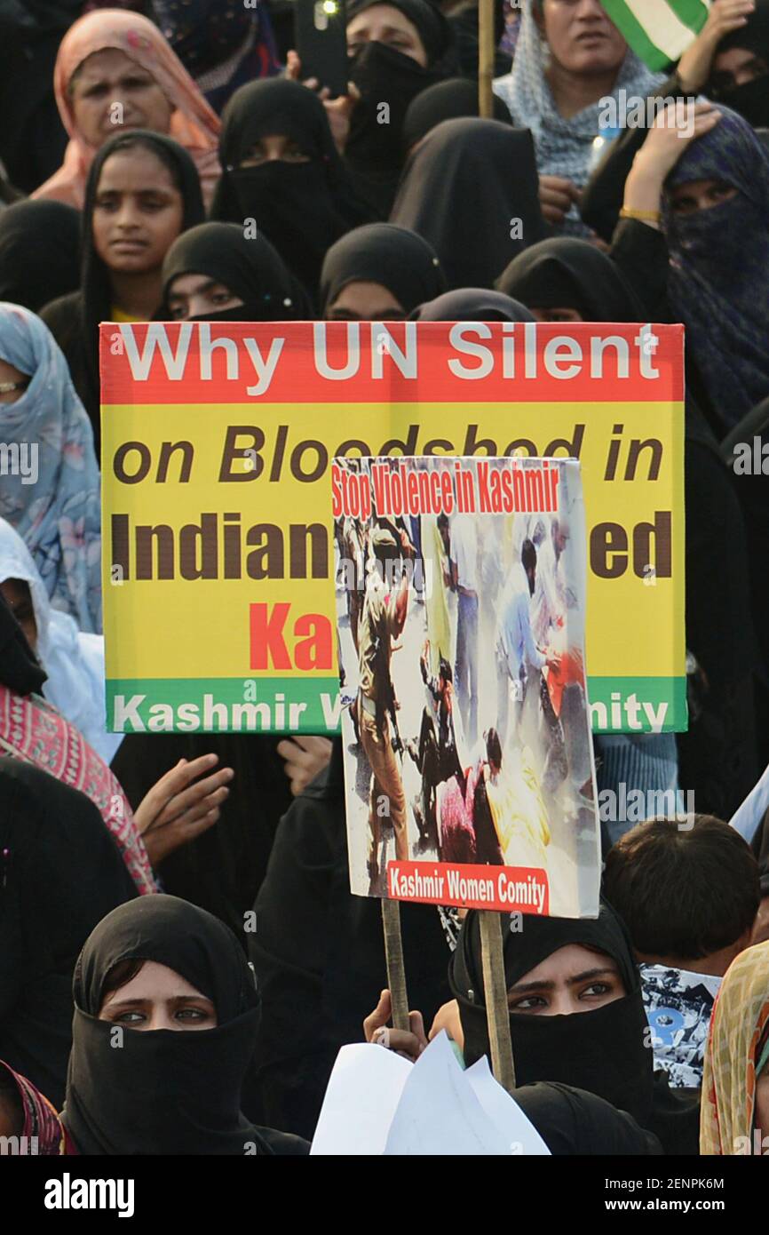 Pakistani activists of Kashmir Women Committee hold placards, banners