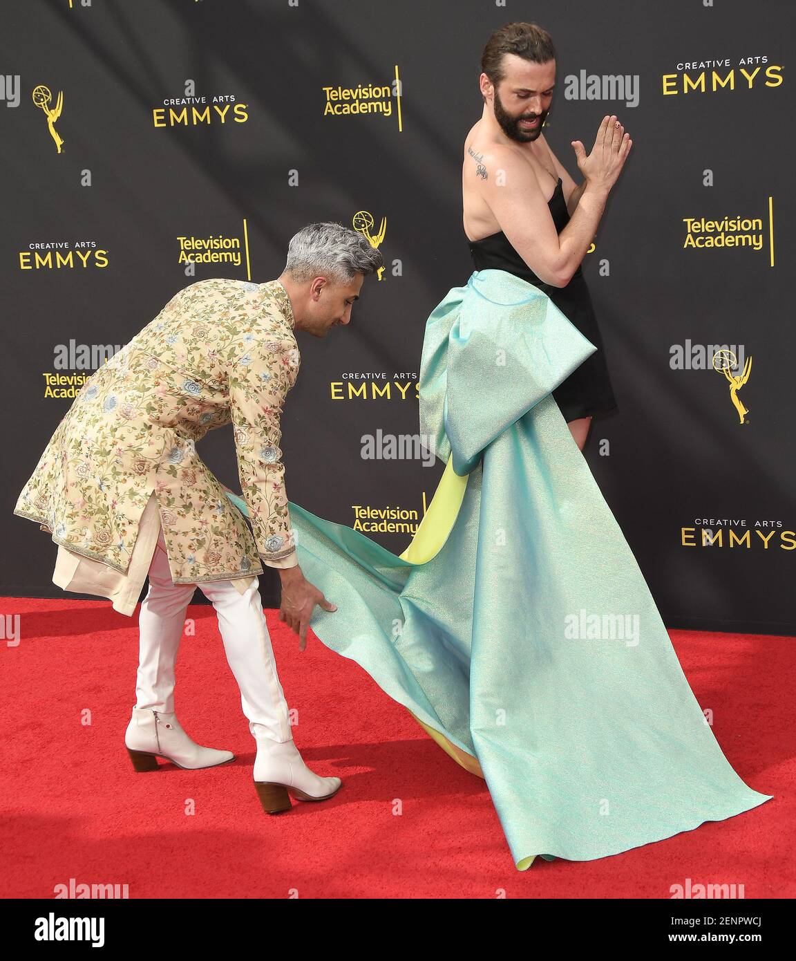 (LR) Tan France fixes Jonathan Van Ness' dress at the 2019 Creative