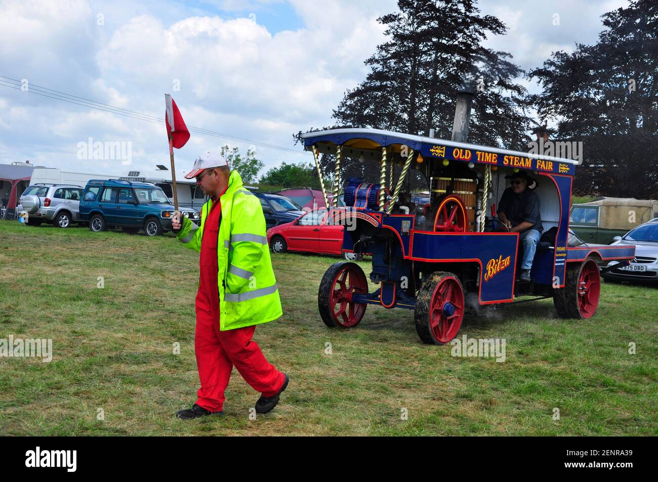 BITZA a replica Old Time Steam Fair engine built from spare parts by J.Borthwick being lead at the Southwick Steam fair by a man with a red flag Stock Photo