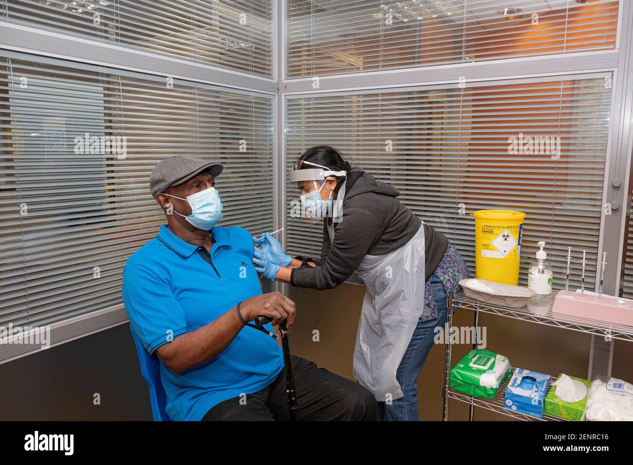 A gentleman receives his COVID-19 vaccination at a vaccination hub in Warwickshire, UK. Stock Photo