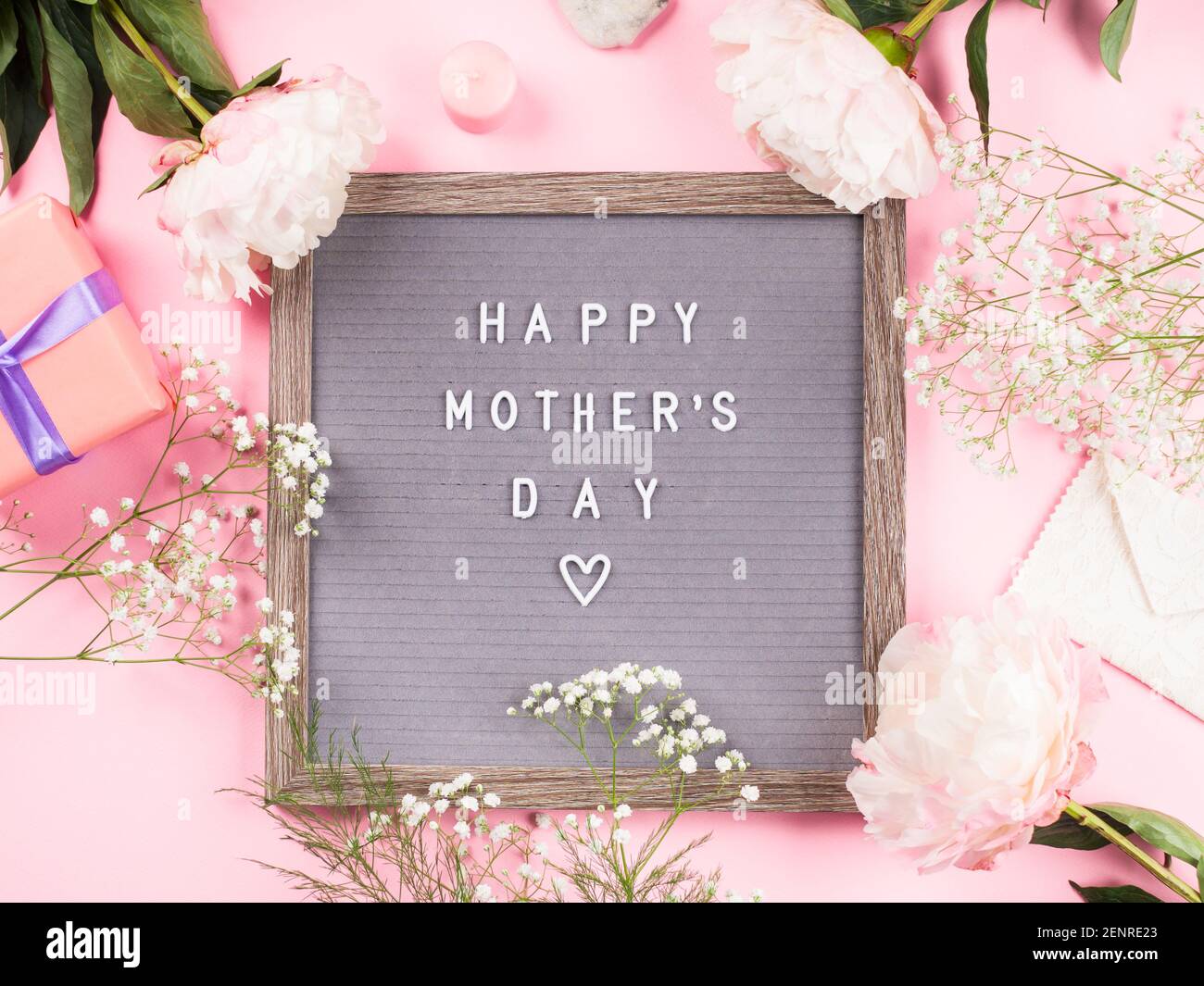 Happy mothers day greetings on letter board on pink background Stock