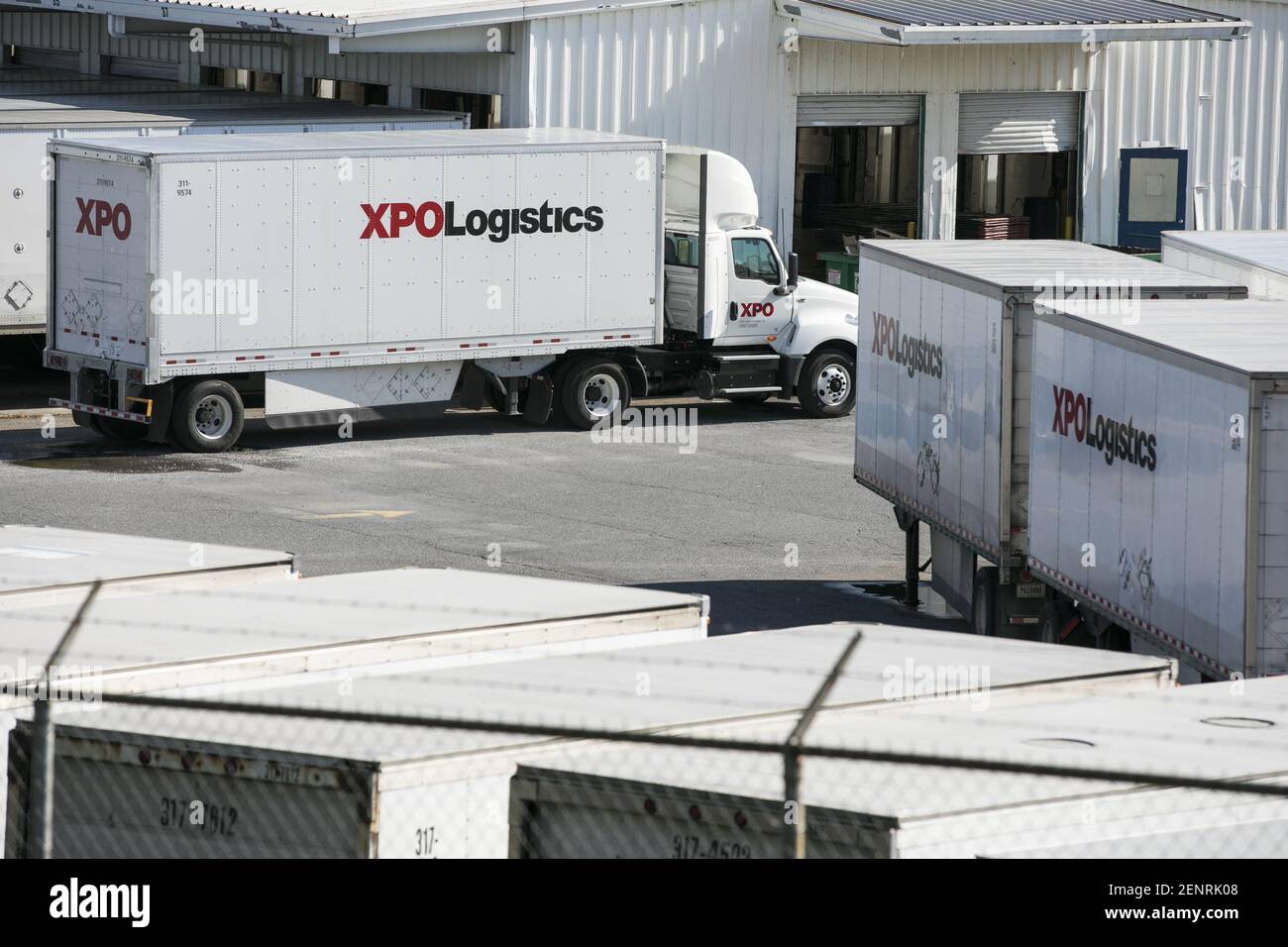 XPO Logistics semitrailer trucks and trailers at a freight facility in