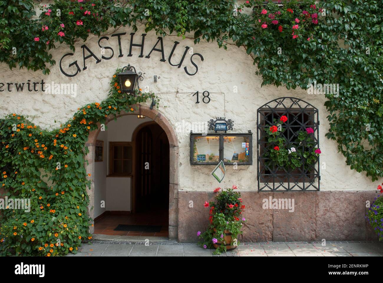 Gasthaus, inn in Bad Goisern with overgrown facade and open door, Inner  Salzkammergut, Austria Stock Photo - Alamy