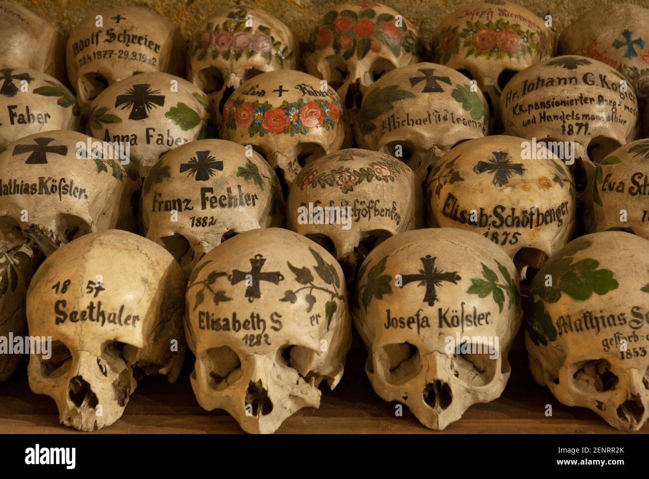painted skulls and bones in the Hallstatt ossuary, Hallstatt, Salzkammergut, Austria Stock Photo