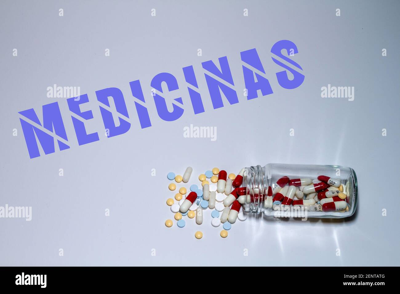 Medicine concept. Pills and capsules come out of a transparent bottle