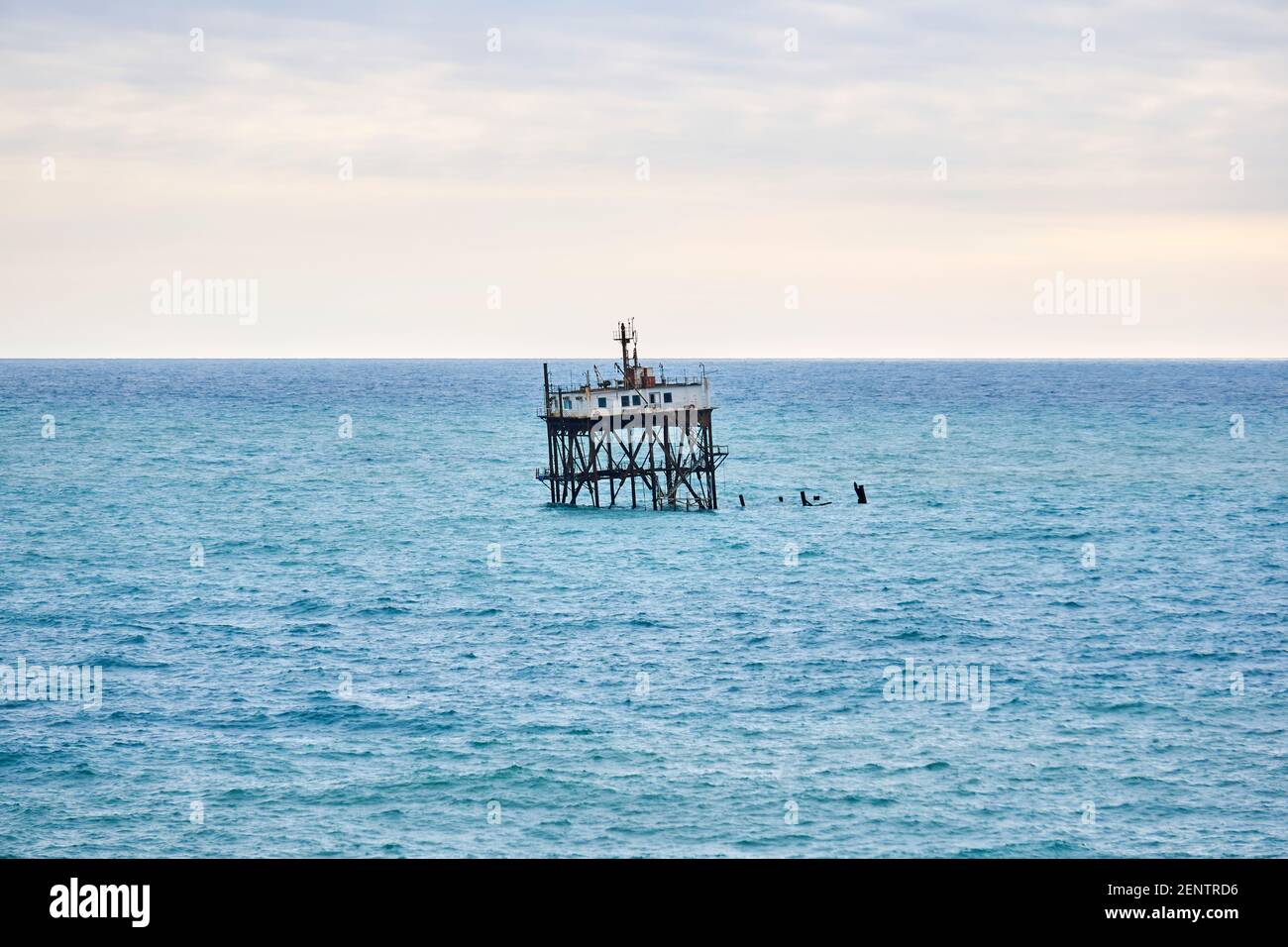 seascape with a rickety structure on the stilts of an mariculture farm Stock Photo