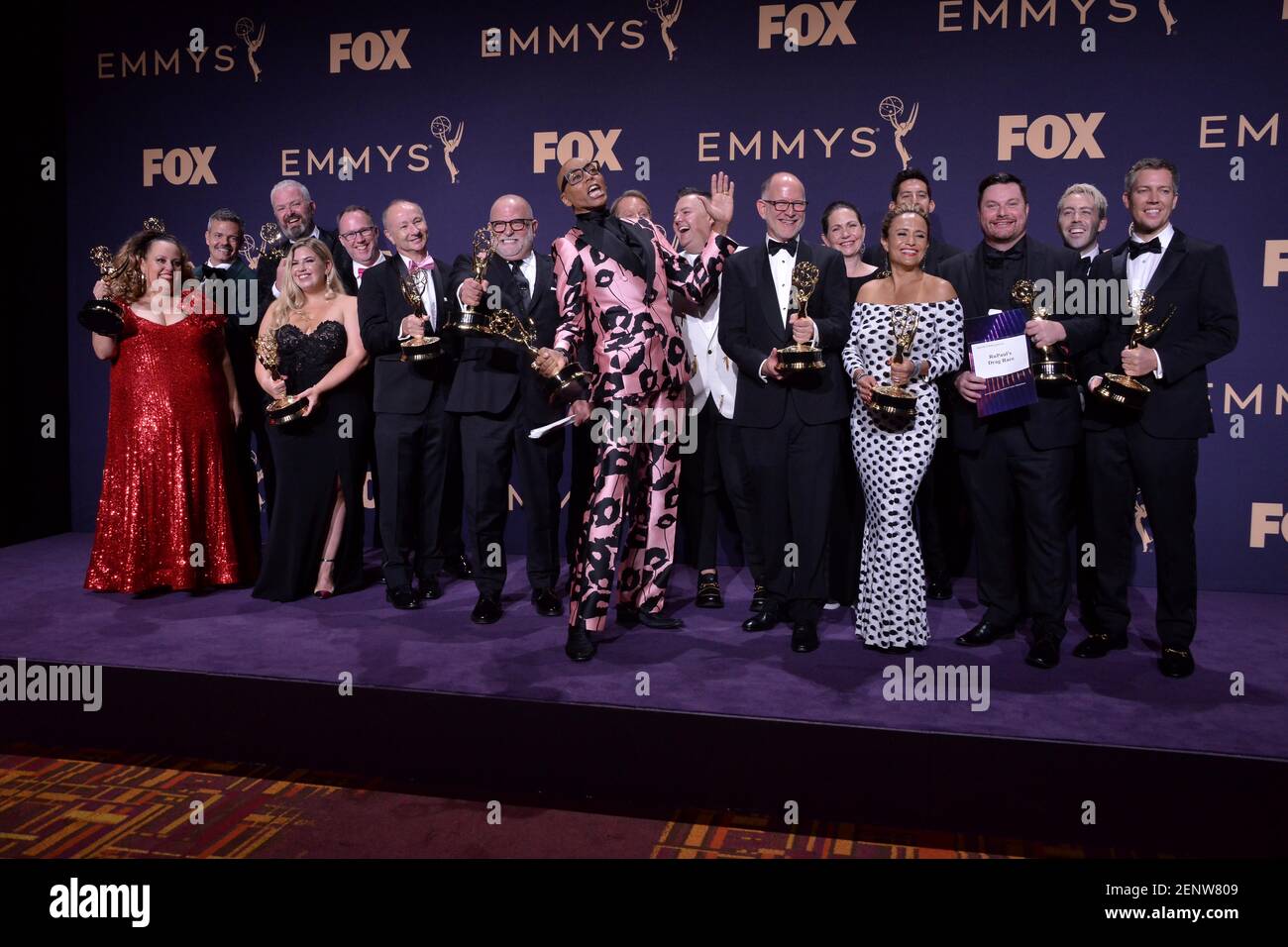 RuPaul and the team behind RuPaul's Drag Race poses in the press room