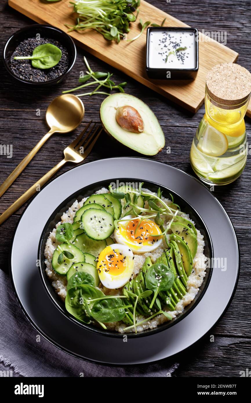 Egg Topped Quinoa Bowl with sunflower microgreens, cucumber, avocado