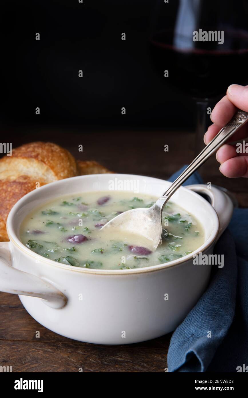 Portuguese Caldo Verde soup with spoon.  Vertical format with copy space. Stock Photo