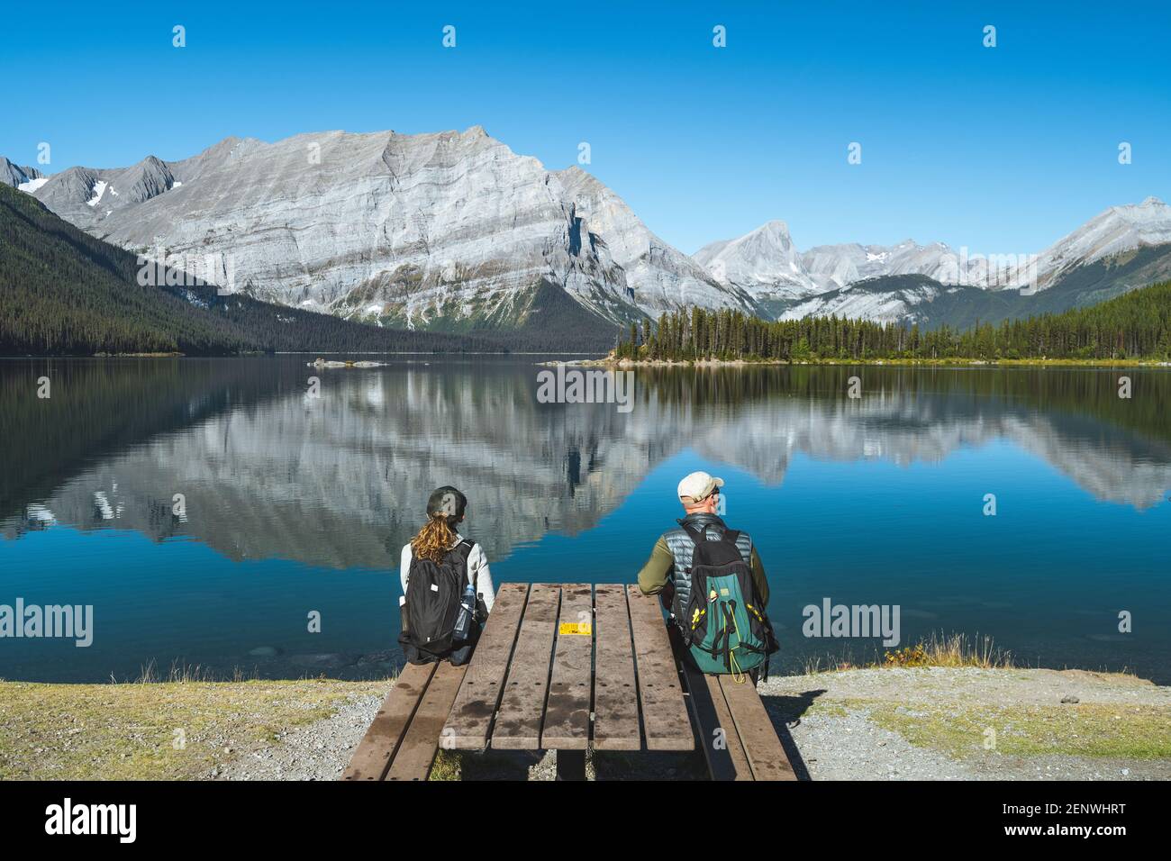 Hikers enjoying the view at Upper Kananaskis Lake during summer, Kananaskis Country, Alberta, Canada. Stock Photo