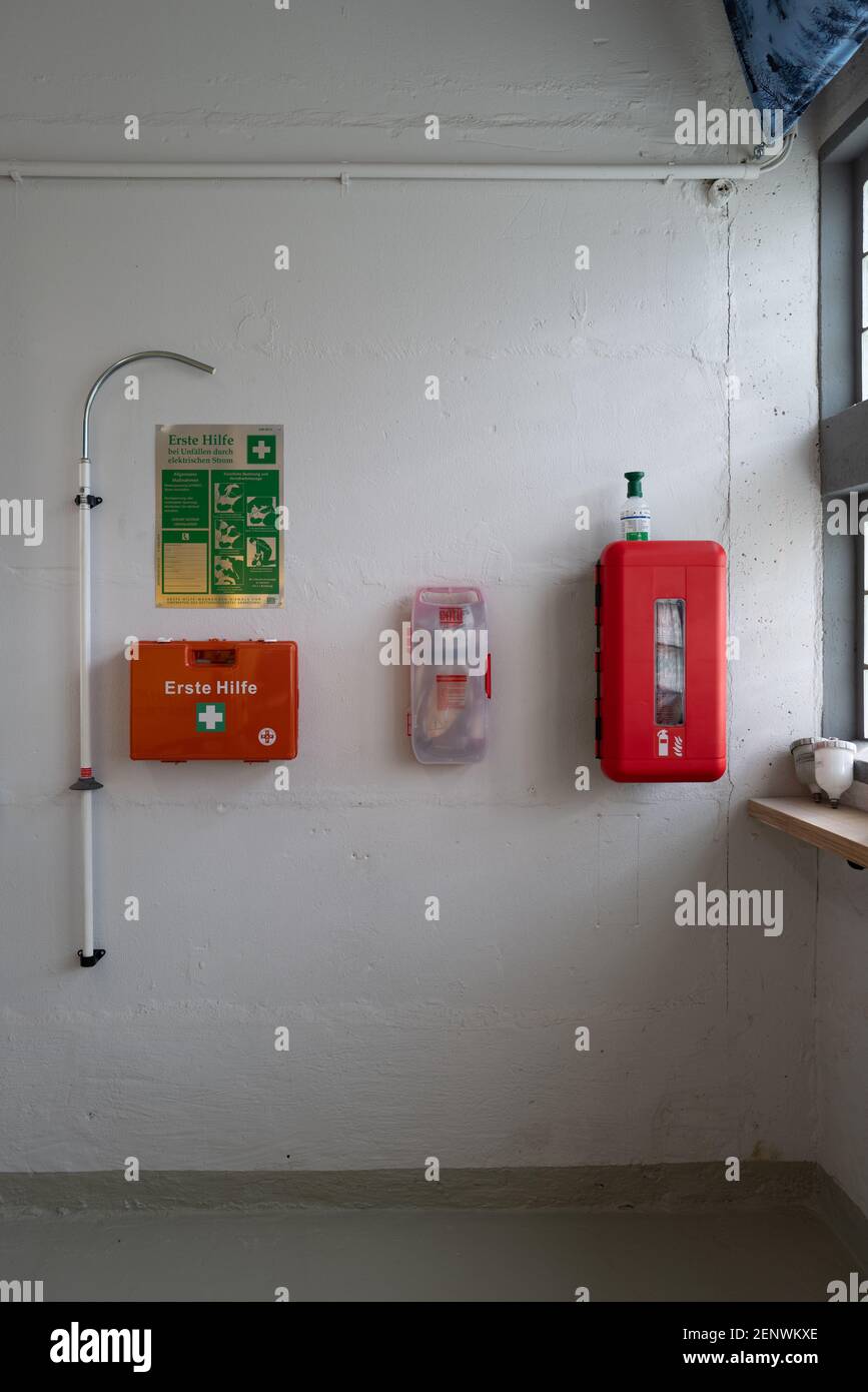 on a white wall emergency kit and a first aid kit Stock Photo - Alamy