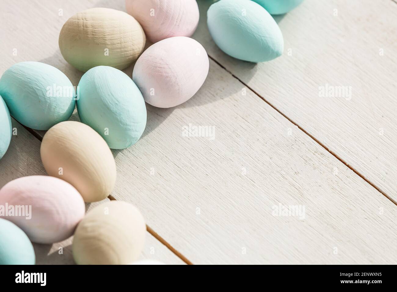 Coloeful easter eggs in nest on pastel color background with space ...