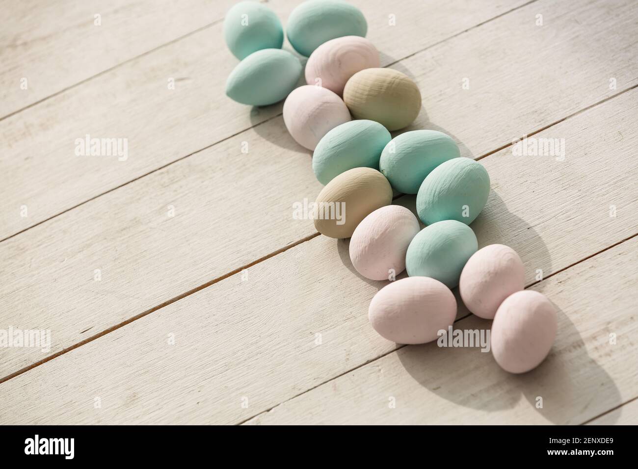 Coloeful easter eggs in nest on pastel color background with space ...