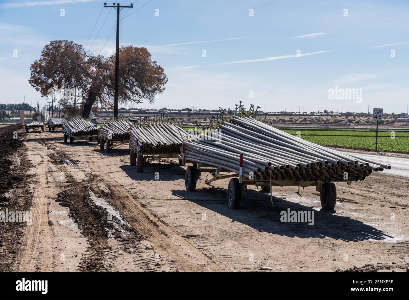 Stacks of irrigation pipe on trailers for use in irrigating the farm fields in the desert around