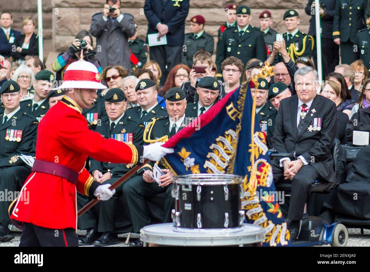 Flag bearer from the Royal Canadian Regiment Color Guard presents the