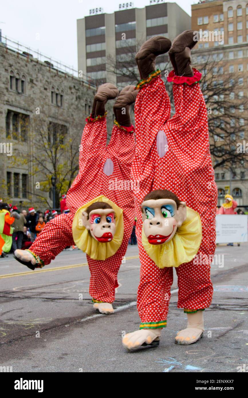 Monkey disguised entertainers walking on hands in celebration of the 109th edition of the Santa Claus Parade. More than a half-million people attend t Stock Photo