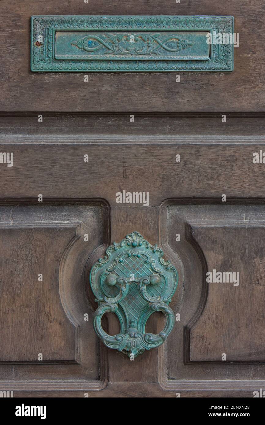 Traditional ornate metal Maltese door knocker and letter box in
