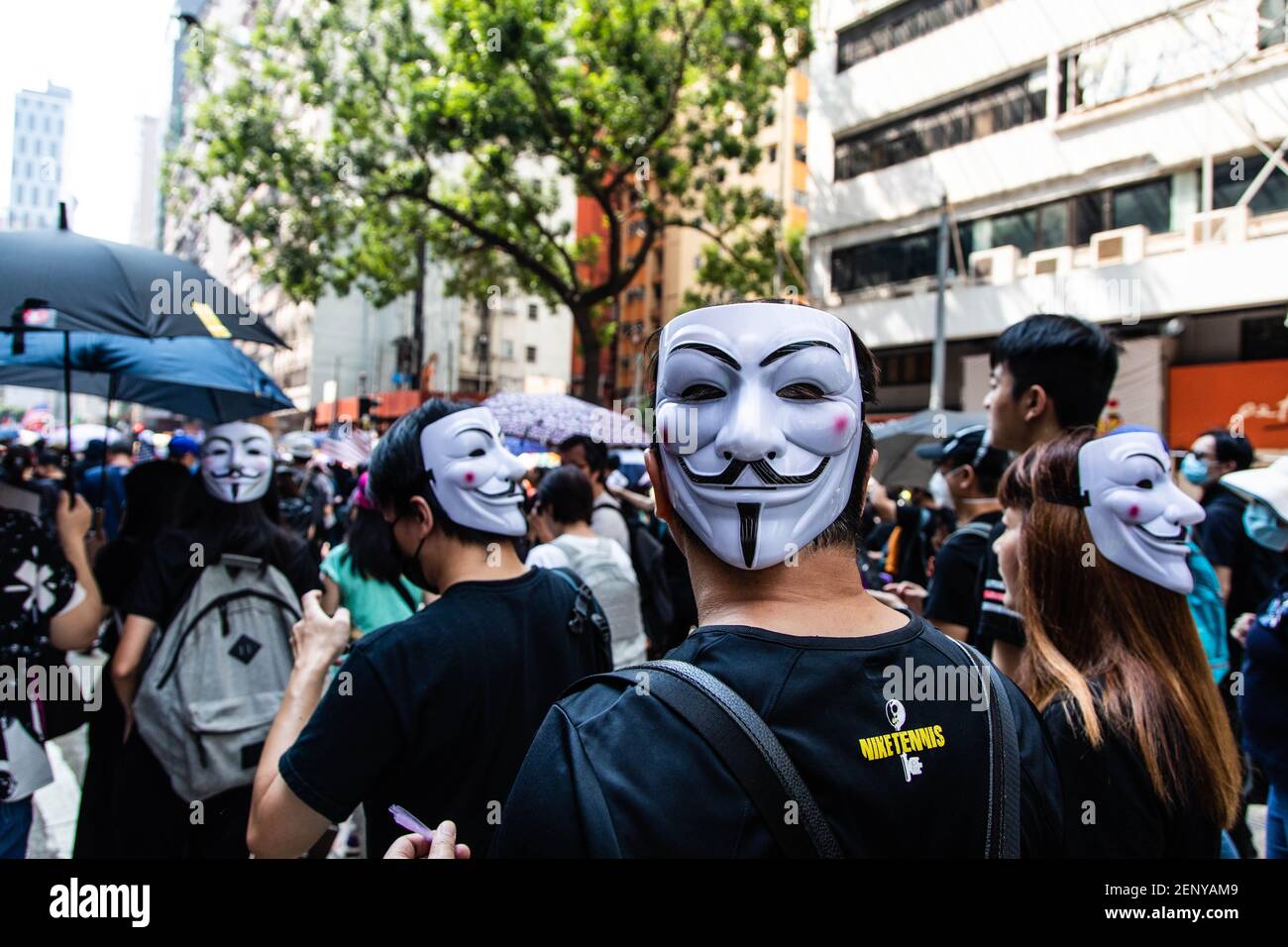Protesters wear Guy Fawkes masks behind their heads during the ...