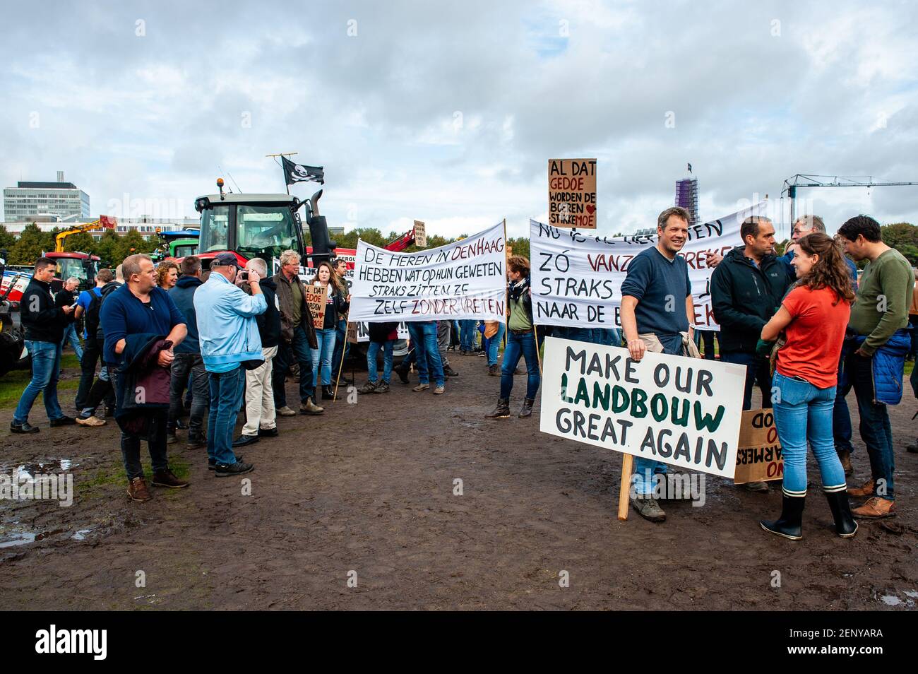 A farmer holding a placards during the demonstration. Thousands of farmers  arrived driving their farm tractors to The Hague to combat the often  negative image of farmers and their farms portrayed in