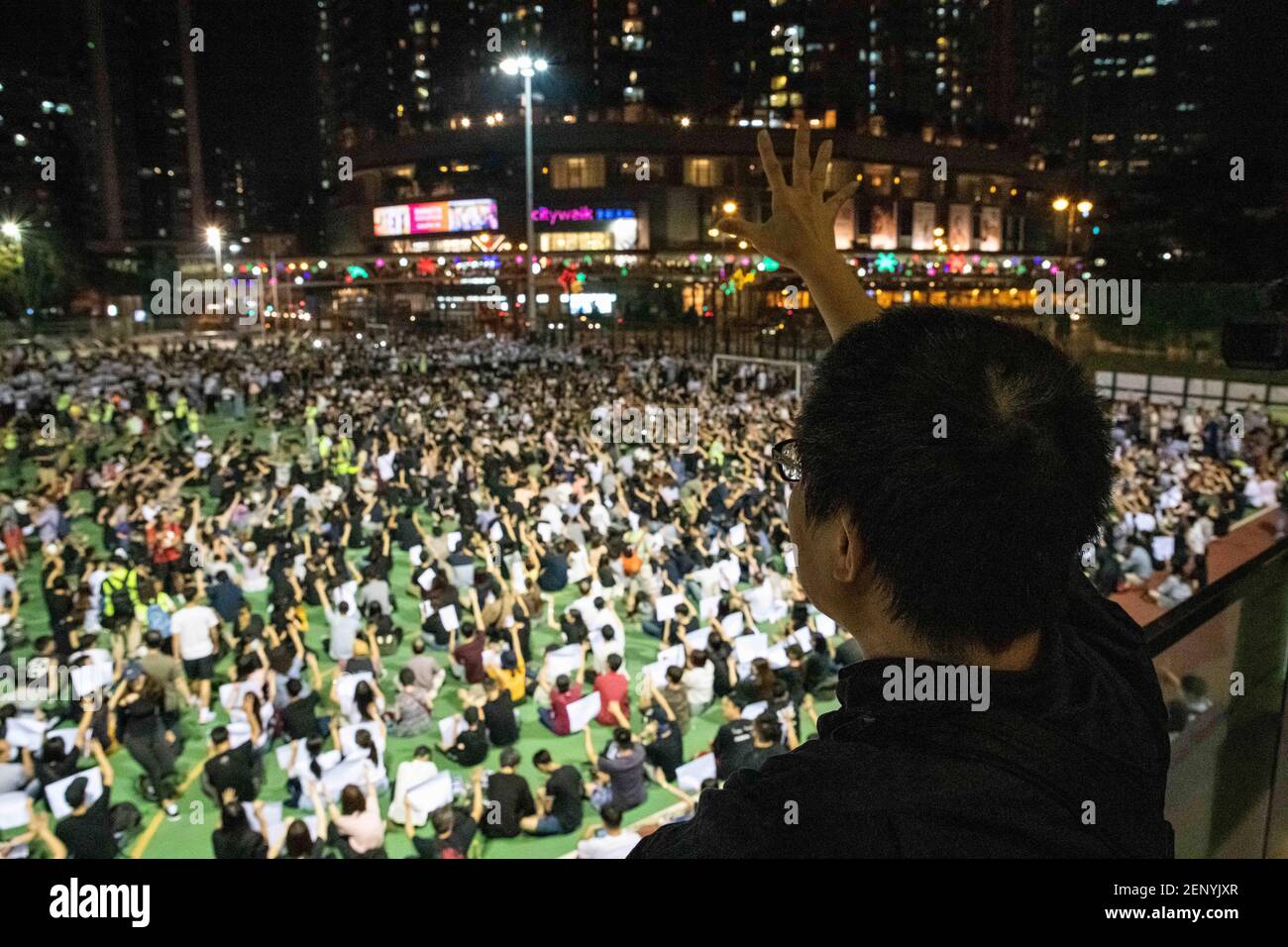 A Hongkonger chants 'five demands, not one less' to a growing crowd at Sha Tsui Road Playground. Hundreds marched through Hong Kong's Tsuen Wan district on Oct. 2, 2019, after police hit an 18-year-old pro-democracy protester with live ammunition during clashes on Oct. 1. (Photo by Alejandro Alvarez/Sipa USA) Stock Photo