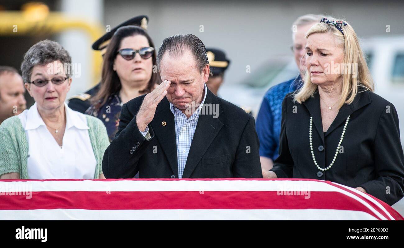 Andrea Bardach, right, comforts her husband, Neil Bardach, as he salutes the remains of his older brother, 1st Lt. Alan Jensen Bardach as his remains are repatriated from Vietnam with a planeside honors ceremony at the Indianapolis International Airport on Thursday, October 3, 2019. 1st Lt. Alan Jensen Bardach was killed during the Vietnam War. 0001 4gallery (Photo by Michelle Pemberton/IndyStar, Indianapolis Star via Imagn Content Services, LLC/USA Today Network/Sipa USA) Stock Photo