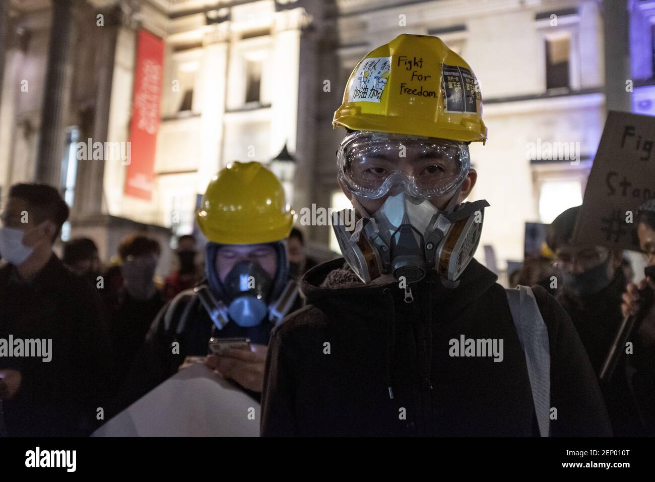 Protesters seen wearing a yellow helmet, googles and a gas mask during the  during the demonstration. Protesters rallied at Trafalgar Square to demand  for democracy and justice in Hong Kong and protesting