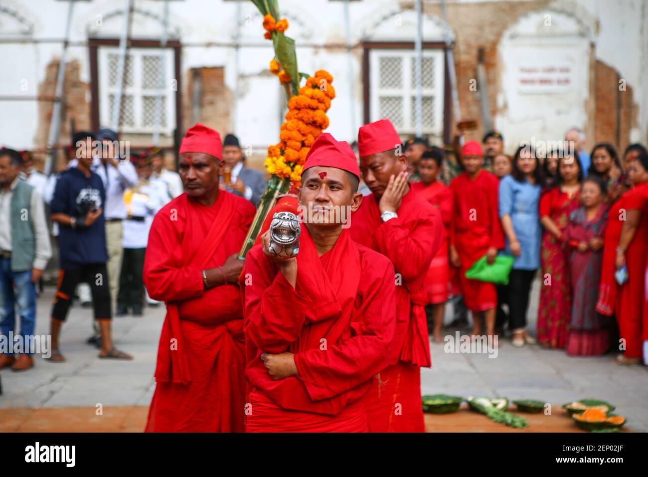 Nepali Hindu devotees carry jamara plants used for blessings as they
