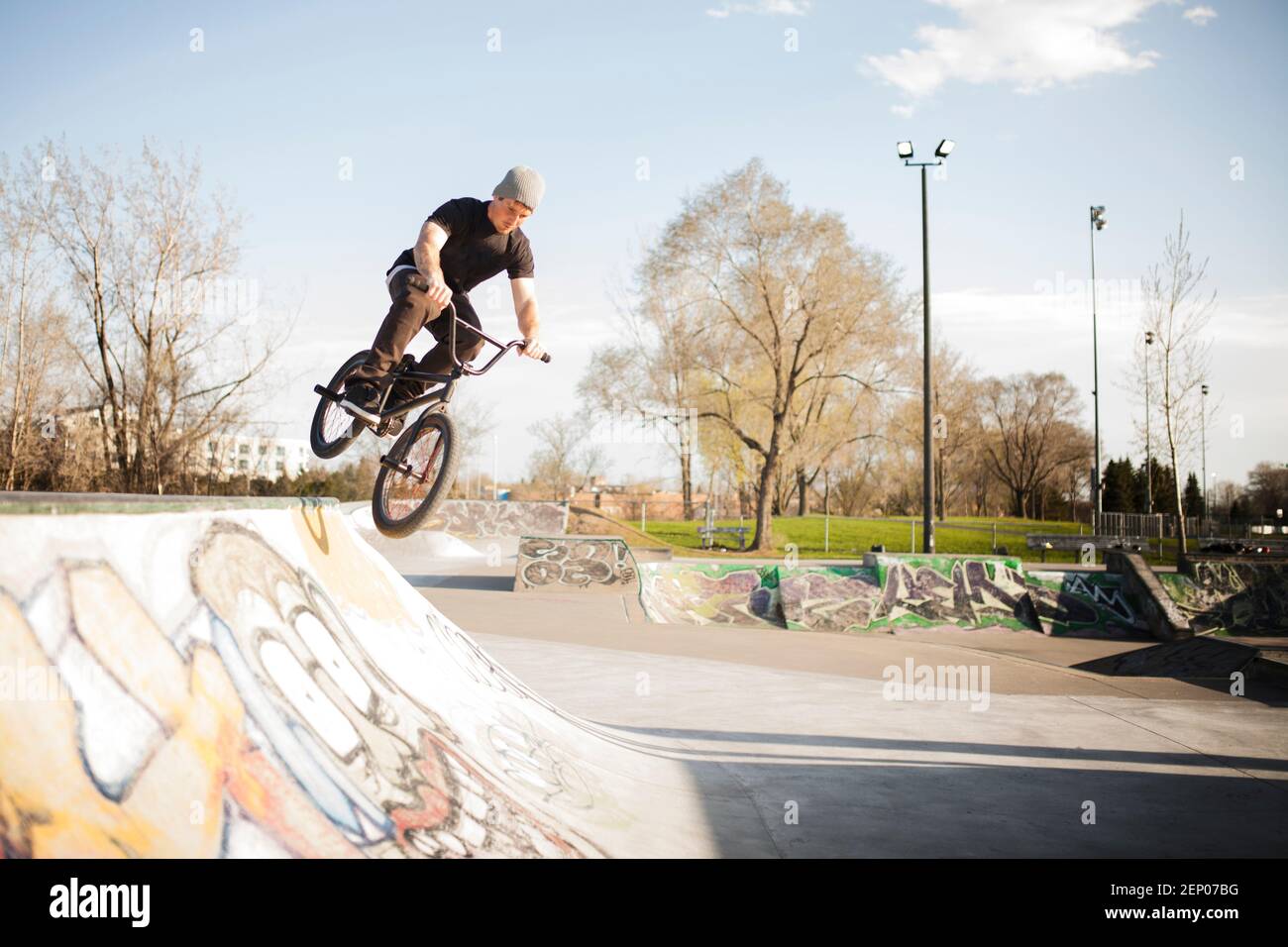 Bmxer in skate park jumping on ramp Stock Photo Alamy
