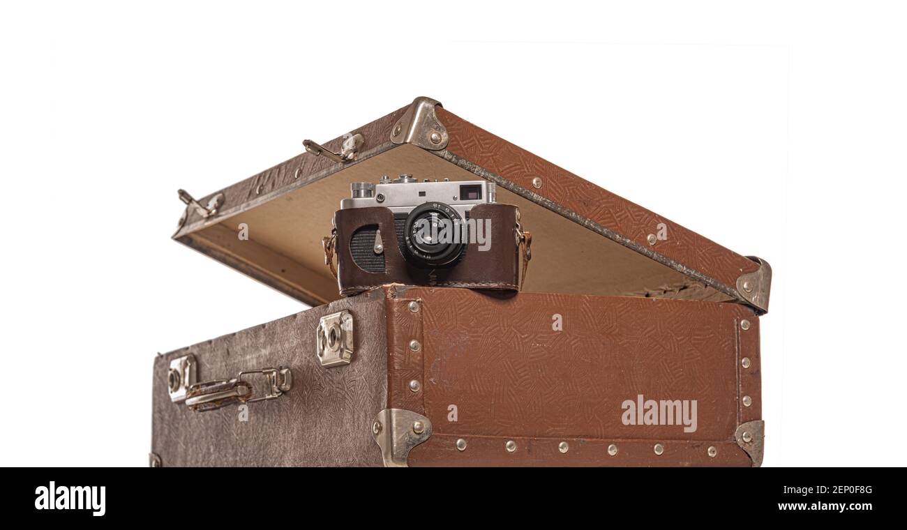 Old suitcase and old camera on white background. Stock Photo