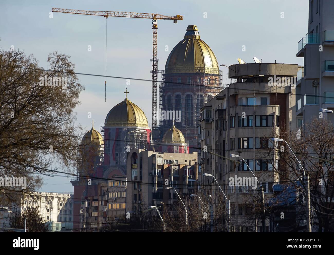 Bucharest, Romania - February 09, 2021: Romanian People’s Salvation Cathedral, building still under construction, can be seen in the background of bui Stock Photo