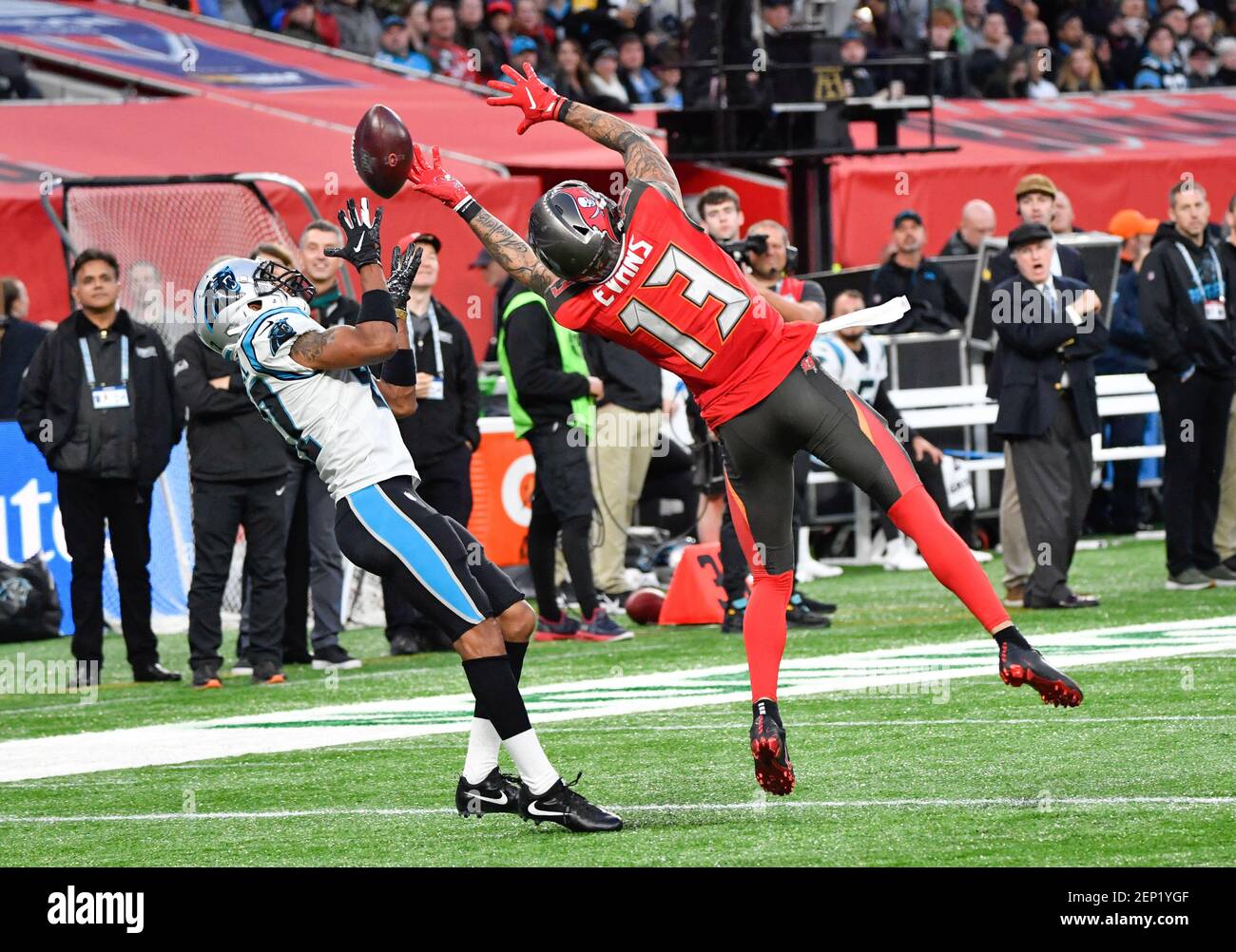 Oct 13, 2019; London, United Kingdom; Tampa Bay Buccaneers wide receiver  Mike Evans (13) and Carolina Panthers defensive back Ross Cockrell (47)  compete for a pass during the fourth quarter of the