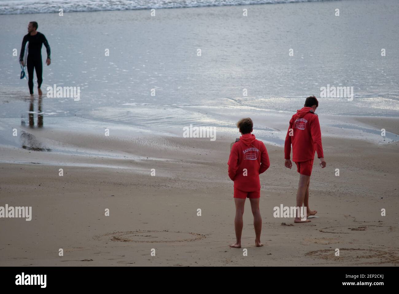 Lifeguard observing sea on sandy beach - a Royalty Free Stock