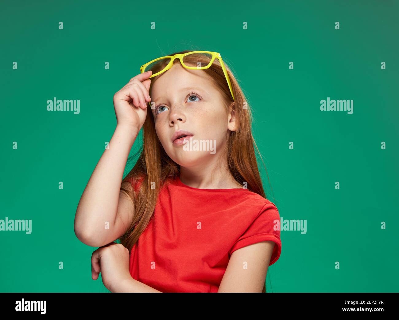 emotional girl with red hair wearing yellow glasses school isolated