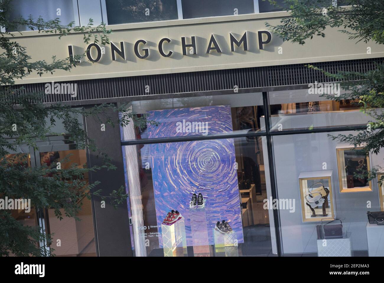 A logo sign outside of a Longchamp retail store location in downtown
