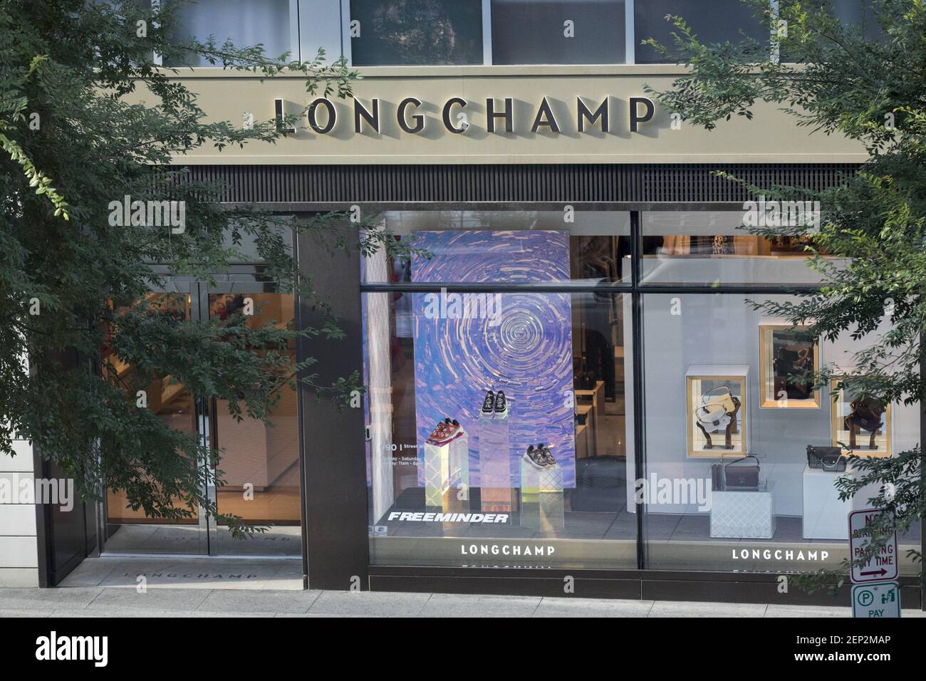 A logo sign outside of a Longchamp retail store location in downtown