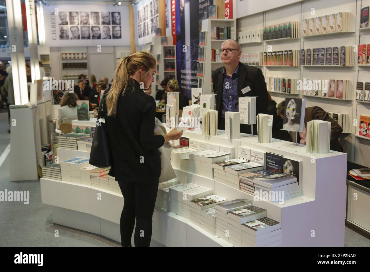 a-woman-looks-at-books-at-the-booth-of-the-german-publisher-c-h-beck
