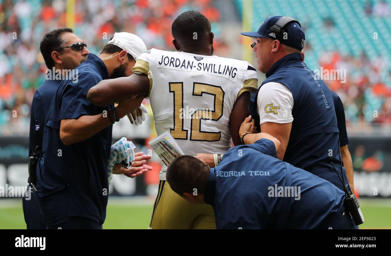 October 19, 2019: Georgia Tech Yellow Jackets linebacker Bruce Jordan-Swilling  (12) is helped off the field, due to an unknown injury, by Georgia Tech  medical and coaching staff during a college football