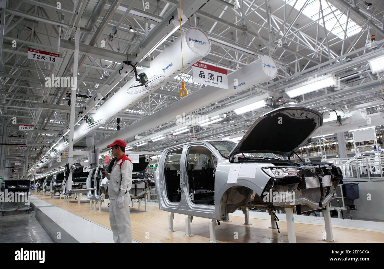 Chinese workers assemble cars on the assembly line at the auto plant of ...