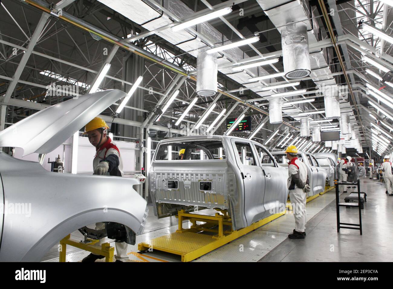 Chinese workers assemble cars on the assembly line at the auto plant of ...
