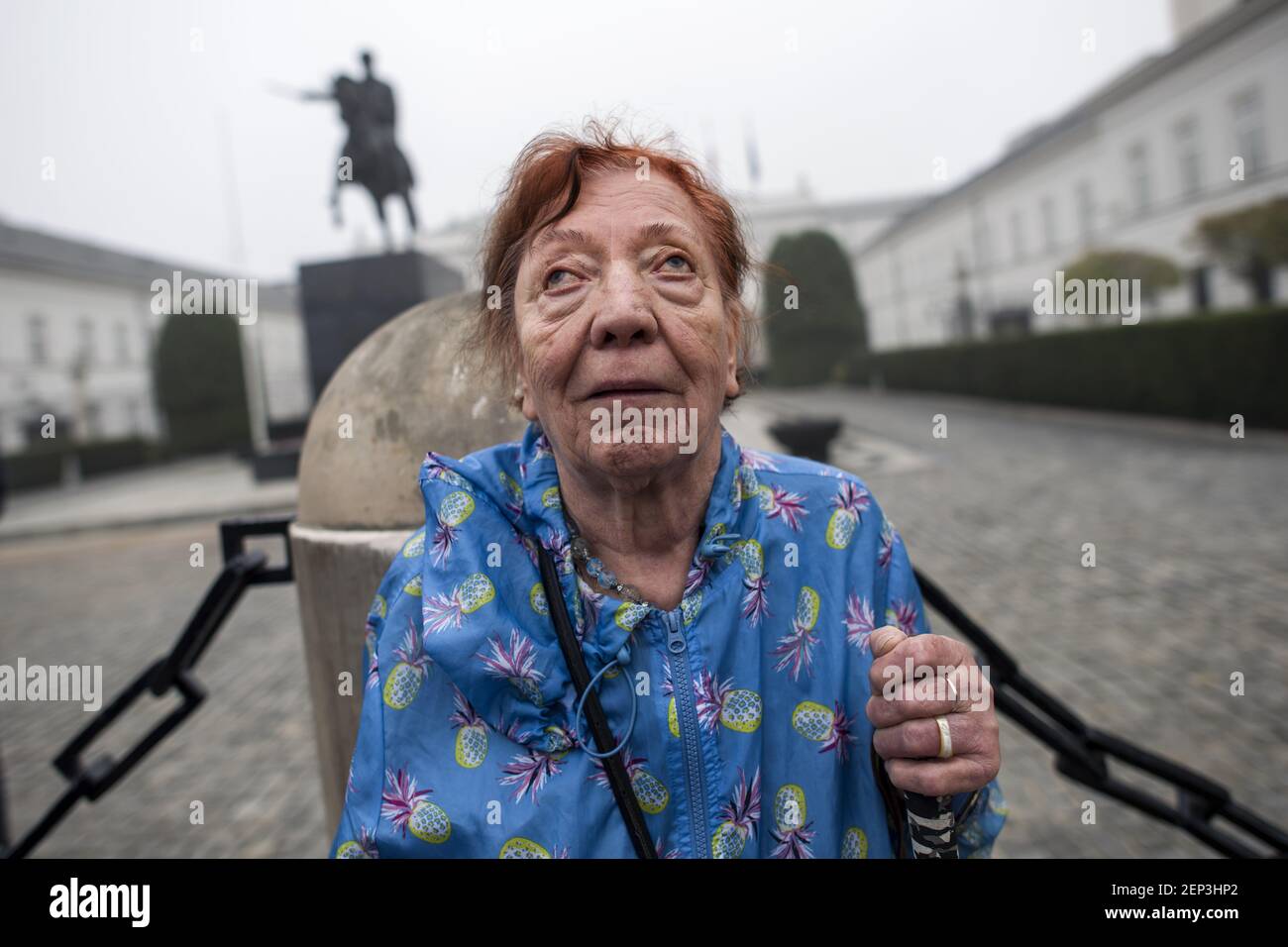 A blind protester holds a white cane seen outside the Presidential